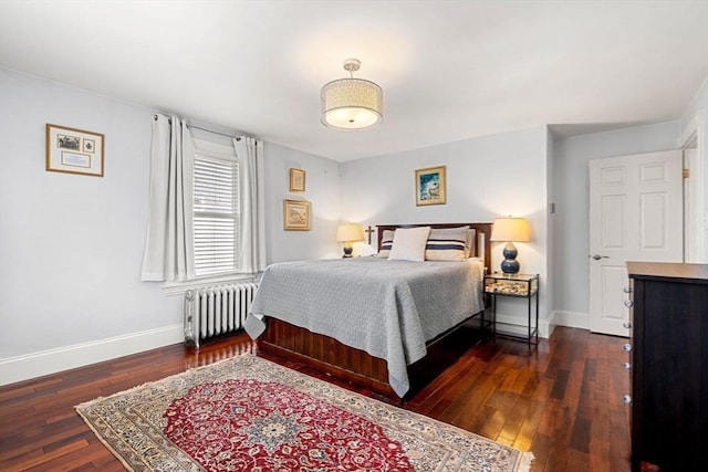 bedroom with radiator heating unit, dark wood finished floors, and baseboards