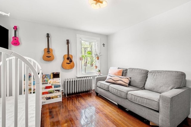 interior space featuring radiator, arched walkways, and wood finished floors