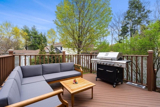 wooden deck with an outdoor living space