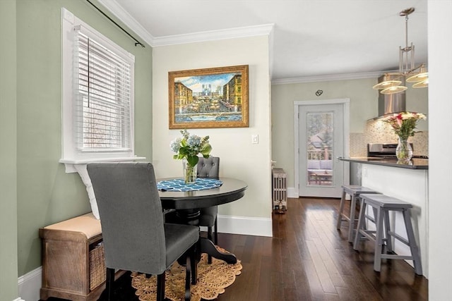 dining space with ornamental molding, a wealth of natural light, and dark wood-type flooring