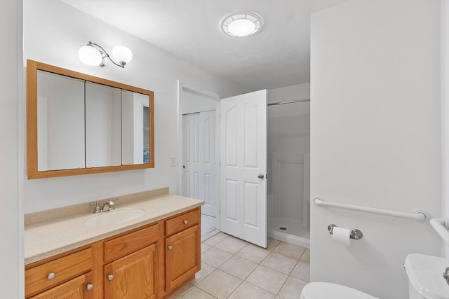 38 Tarbell St Unit 1B, Pepperell, MA 01463 - bathroom with toilet, a stall shower, tile patterned floors, and vanity