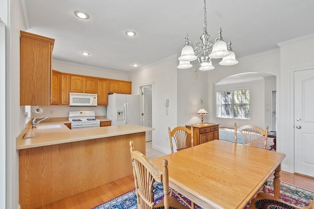 38 Tarbell St Unit 1B, Pepperell, MA 01463 - dining room featuring arched walkways, a chandelier, crown molding, light wood-style floors, and recessed lighting