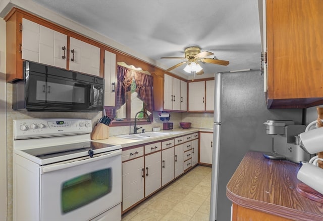 kitchen featuring white cabinetry, sink, ceiling fan, white electric range, and stainless steel fridge