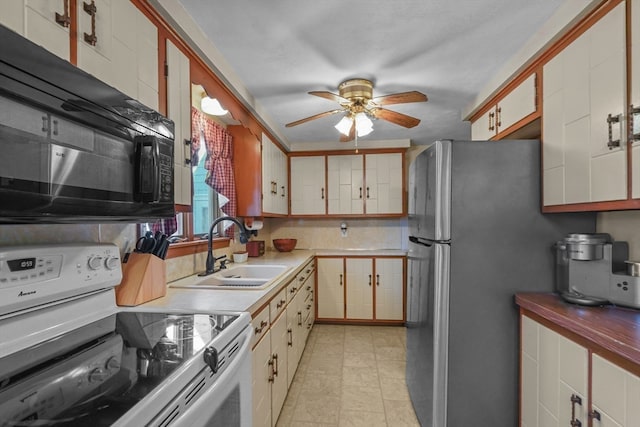 kitchen with stainless steel fridge, ceiling fan, sink, white electric range, and white cabinetry