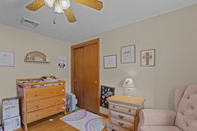 sitting room featuring ceiling fan and wood-type flooring