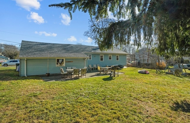 rear view of house with a yard and a patio