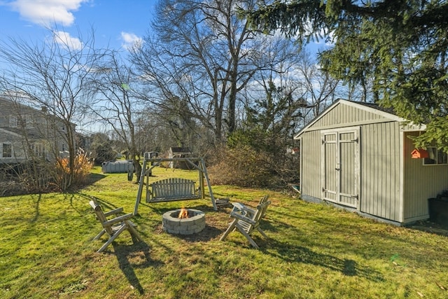 view of yard with a fire pit and a shed