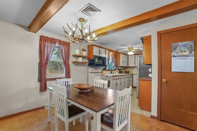 tiled dining room with beam ceiling, ceiling fan with notable chandelier, and sink