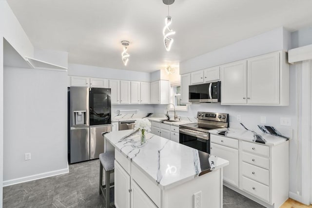70 Granby Hts Unit 70, Granby, MA 01033 - kitchen with stainless steel appliances, a kitchen island, white cabinets, and light stone countertops