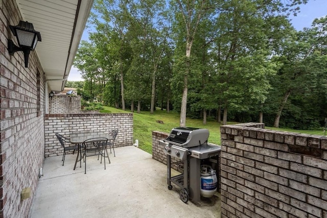 70 Granby Hts Unit 70, Granby, MA 01033 - view of patio featuring a grill, outdoor dining space, and view of scattered trees