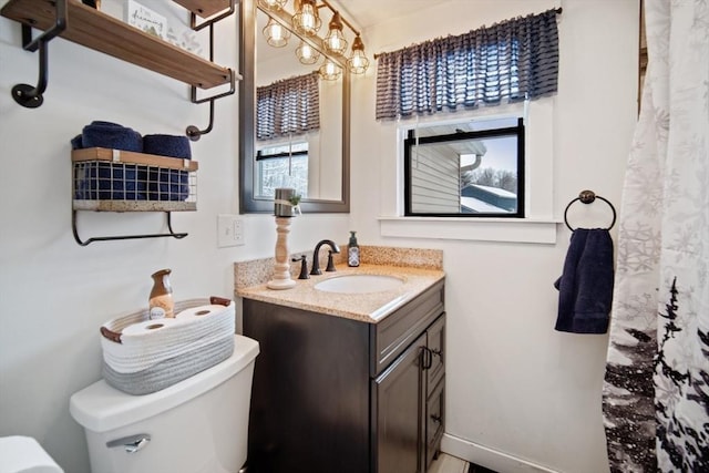 bathroom featuring toilet and vanity