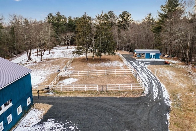 yard layered in snow featuring an outbuilding and a rural view