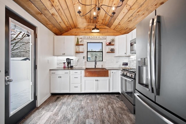 kitchen with white cabinets, appliances with stainless steel finishes, and wood ceiling