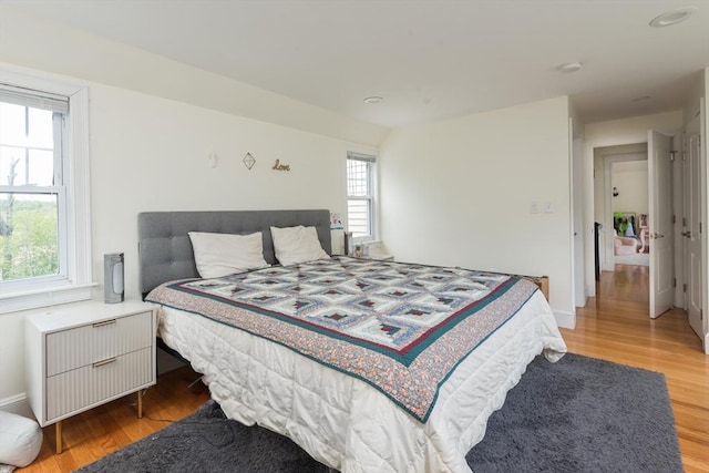bedroom featuring light wood-type flooring and radiator heating unit