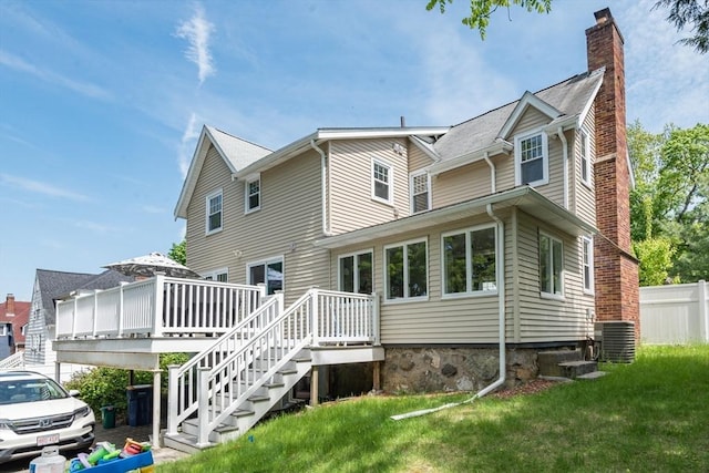 rear view of house with a chimney, a wooden deck, cooling unit, and stairway