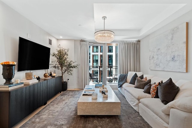 living room with visible vents and a chandelier