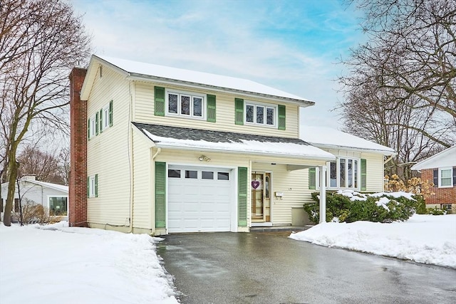 view of front facade with aphalt driveway, a chimney, and an attached garage