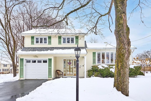 view of front of property featuring aphalt driveway and an attached garage