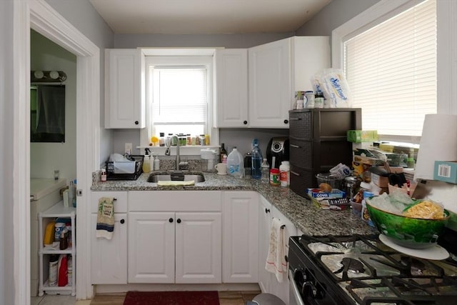 13 Main St, Framingham, MA 01702 - kitchen with white cabinetry, gas range oven, and light stone counters