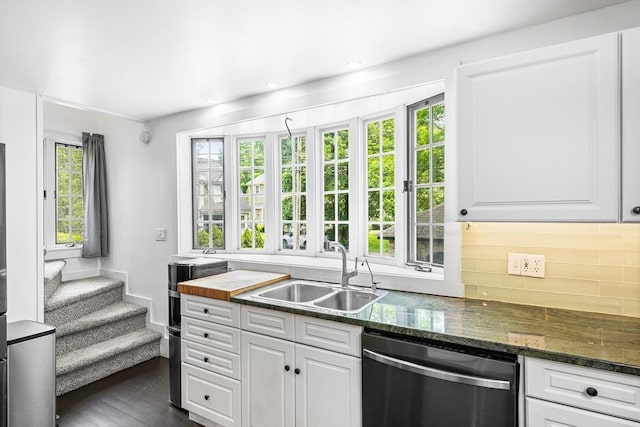 11 N Hancock St, Lexington, MA 02420 - kitchen featuring stainless steel dishwasher, a sink, white cabinets, decorative backsplash, and dark stone counters