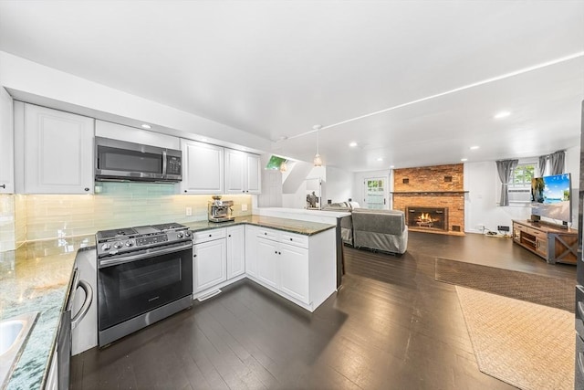 11 N Hancock St, Lexington, MA 02420 - kitchen featuring stainless steel appliances, a peninsula, open floor plan, white cabinetry, and recessed lighting