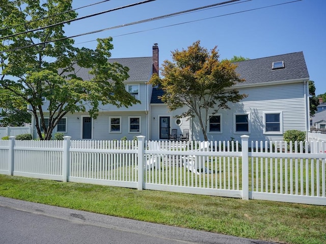 19 Mohawk Rd, Burlington, MA 01803 - view of front of home featuring a chimney, roof with shingles, a front lawn, and a fenced front yard