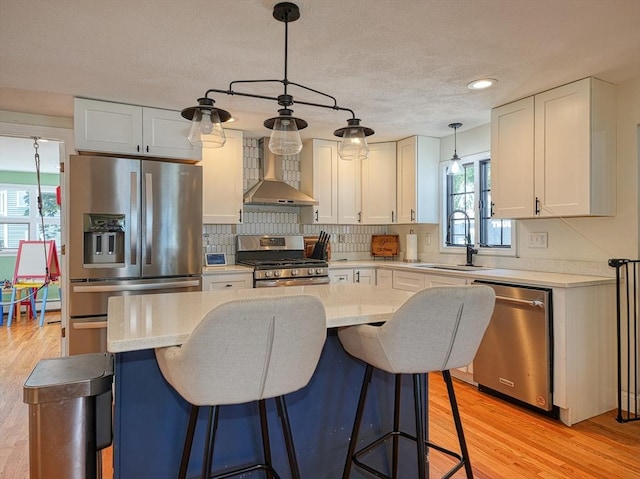19 Mohawk Rd, Burlington, MA 01803 - kitchen with wall chimney range hood, light countertops, stainless steel appliances, and a sink