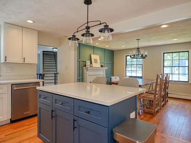 19 Mohawk Rd, Burlington, MA 01803 - kitchen featuring stainless steel dishwasher, white cabinetry, light countertops, and light wood-type flooring