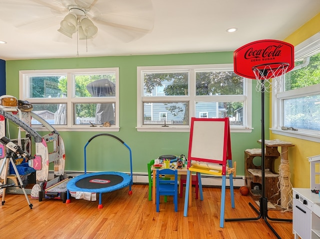 rec room featuring light wood-type flooring and ceiling fan