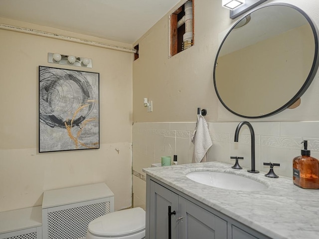 19 Mohawk Rd, Burlington, MA 01803 - half bath with toilet, tile walls, vanity, and a wainscoted wall