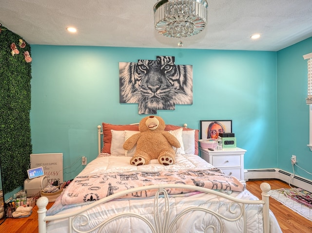 bedroom with wood-type flooring and a textured ceiling