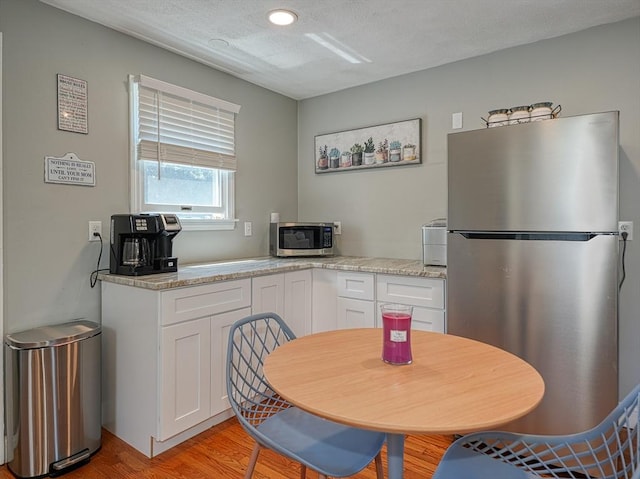 19 Mohawk Rd, Burlington, MA 01803 - kitchen with white cabinets, light wood-type flooring, stainless steel appliances, and recessed lighting