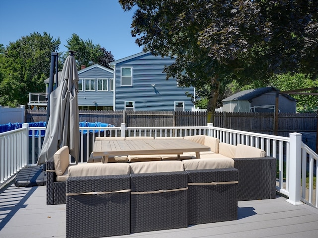 wooden terrace with an outdoor living space