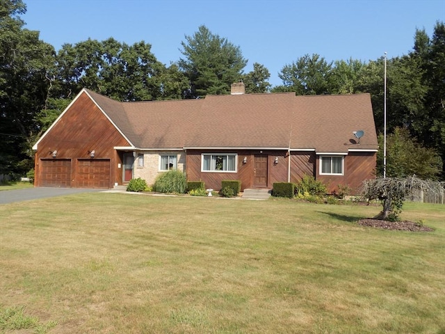 single story home featuring a garage and a front lawn