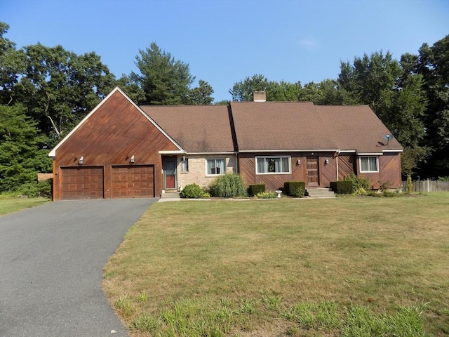 ranch-style house with a garage and a front yard