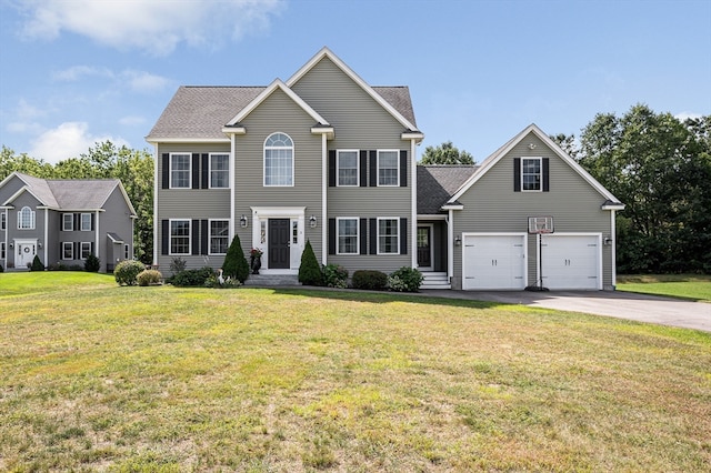 colonial house featuring a garage and a front yard