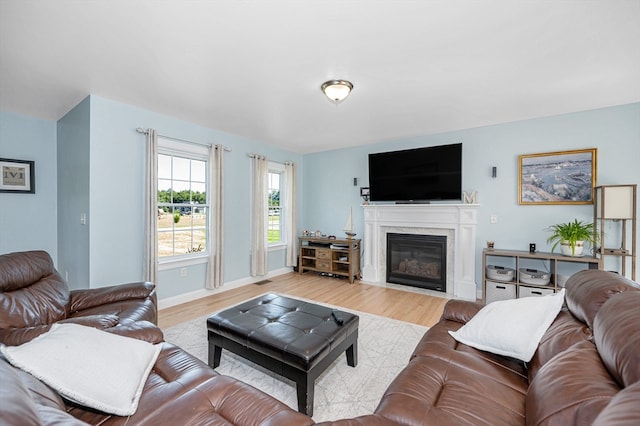 living room featuring light hardwood / wood-style flooring and a fireplace