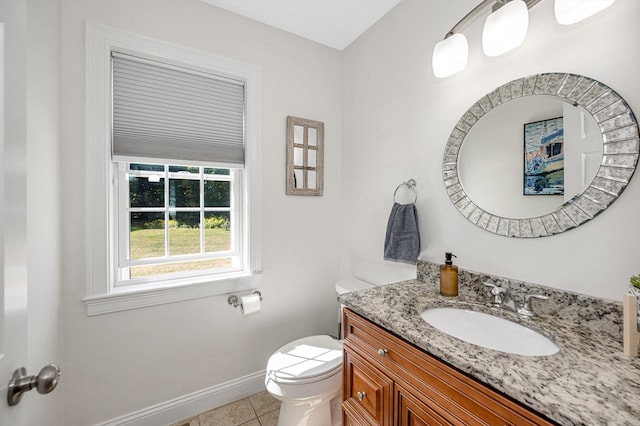 bathroom featuring tile patterned flooring, vanity, and toilet