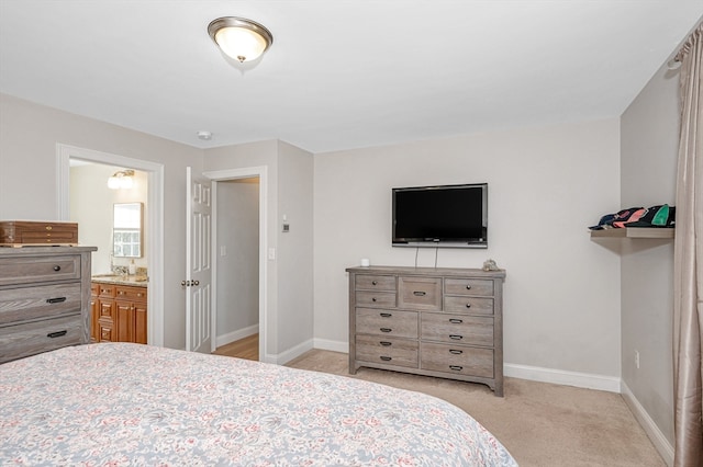 bedroom featuring light carpet and connected bathroom