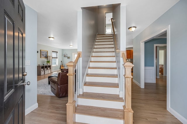 staircase with hardwood / wood-style floors