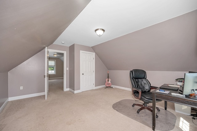 office space with vaulted ceiling and light carpet