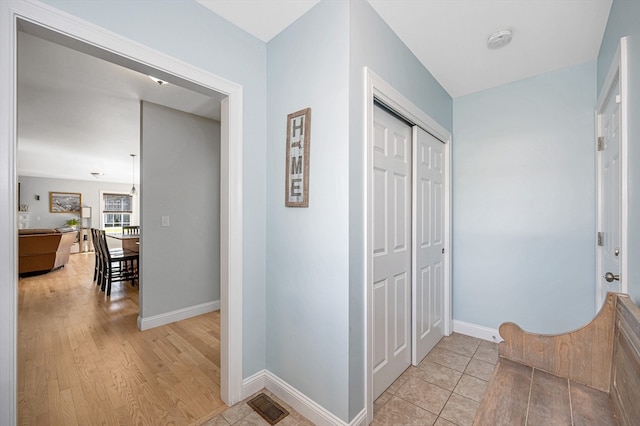 corridor with light hardwood / wood-style floors