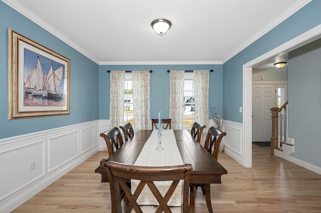 dining room featuring ornamental molding and light hardwood / wood-style flooring