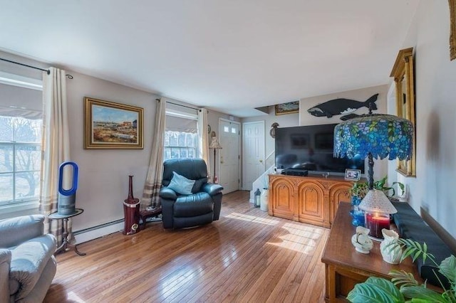 living area featuring a baseboard radiator and light wood-style floors