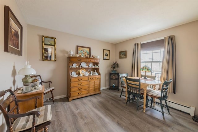 dining area featuring light wood-type flooring and baseboards