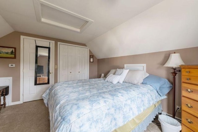 carpeted bedroom with attic access and vaulted ceiling