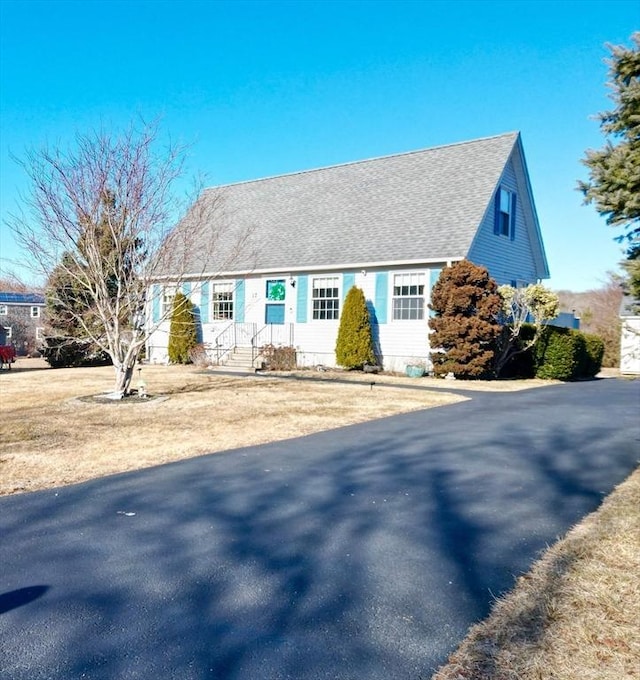 view of front of property featuring roof with shingles