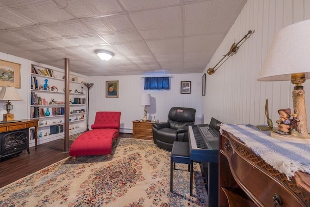 living area with a baseboard heating unit and wood finished floors