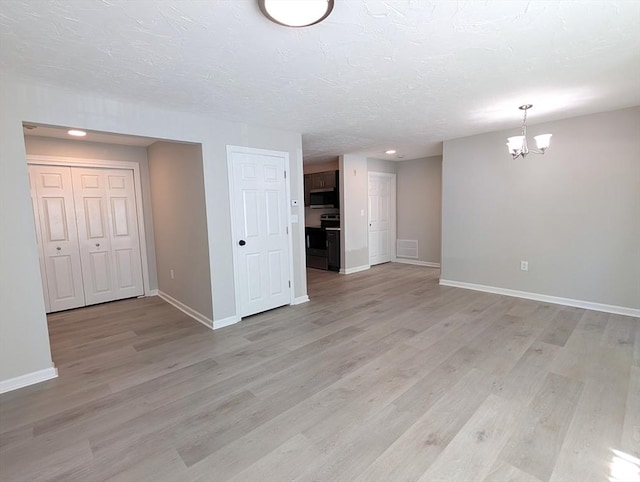 3202 Halcyon Dr Unit 3202, Worcester, MA 01606 - unfurnished living room featuring a chandelier, light wood-type flooring, recessed lighting, and a textured ceiling