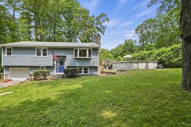 175 Armsby Rd, Sutton, MA 01590 - raised ranch with a chimney, an attached garage, a front yard, an outdoor pool, and concrete driveway